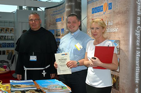 Father Paweł Paterek (in the centre) was the first winner of the 2014 lottery